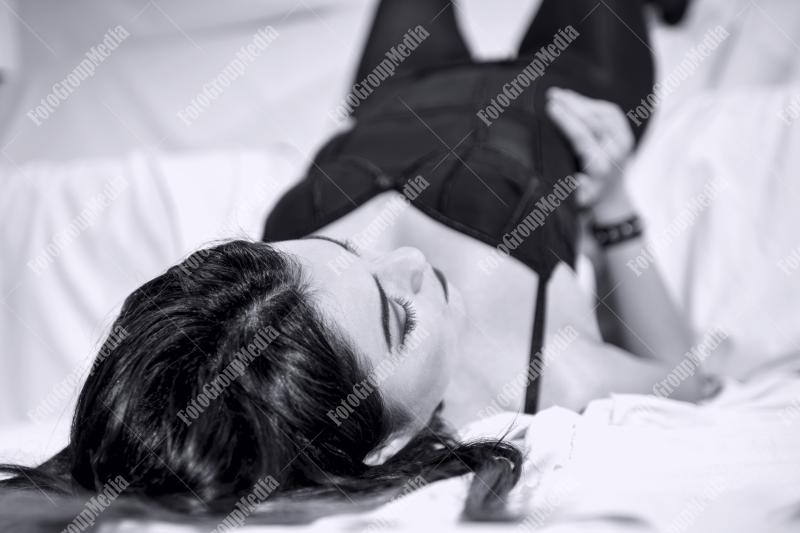 Young woman relaxes on a plush white sofa