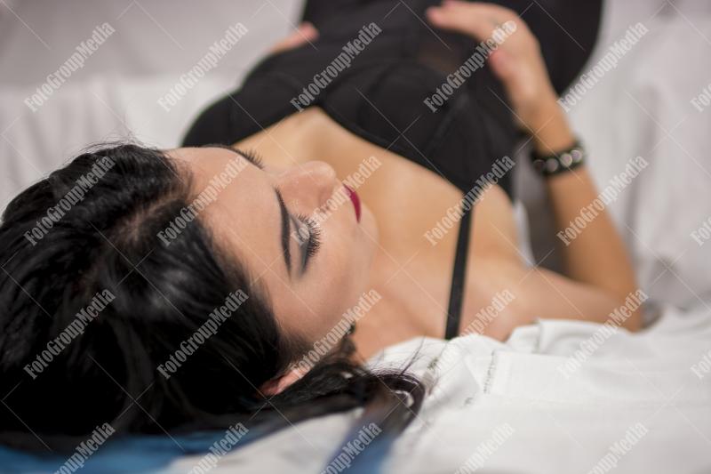 Young woman relaxes on a plush white sofa