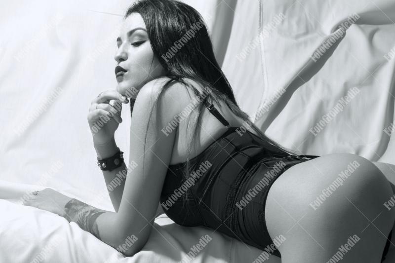 Woman posing in lingerie on white background