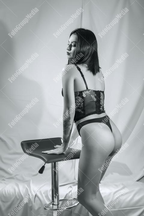 Woman posing in lingerie on white background