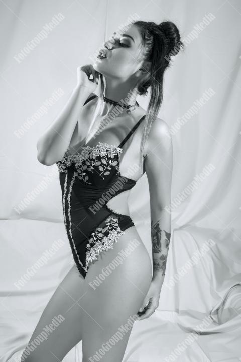 Woman posing in lingerie on white background