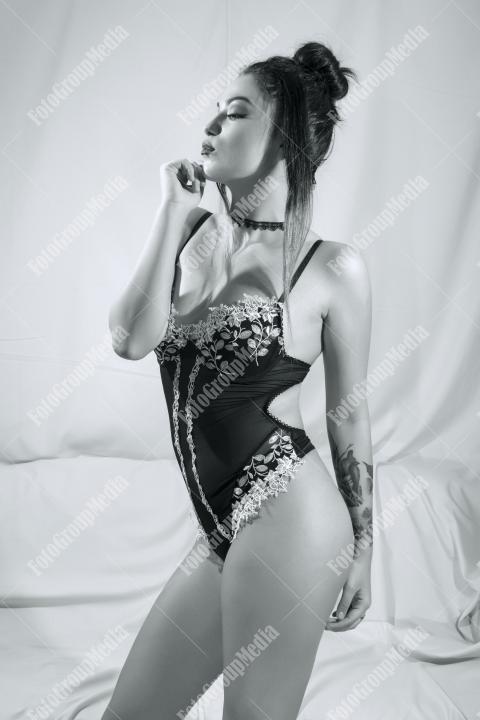 Woman posing in lingerie on white background