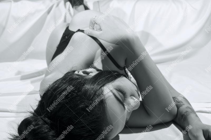 Woman posing in lingerie on white background