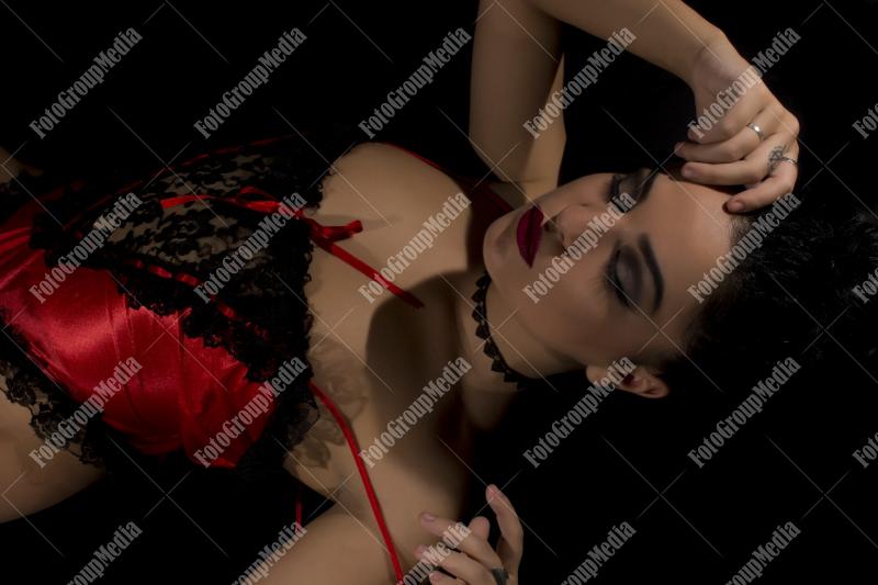 Woman posing in lingerie on black background