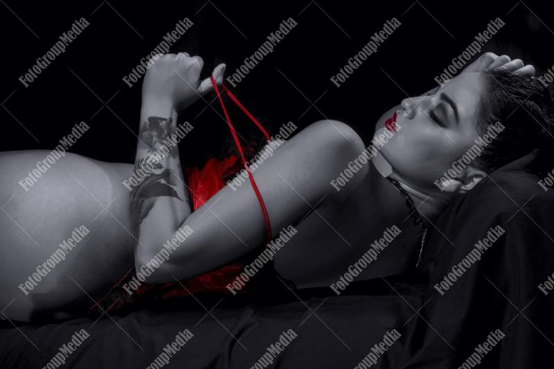 Woman posing in lingerie on black background