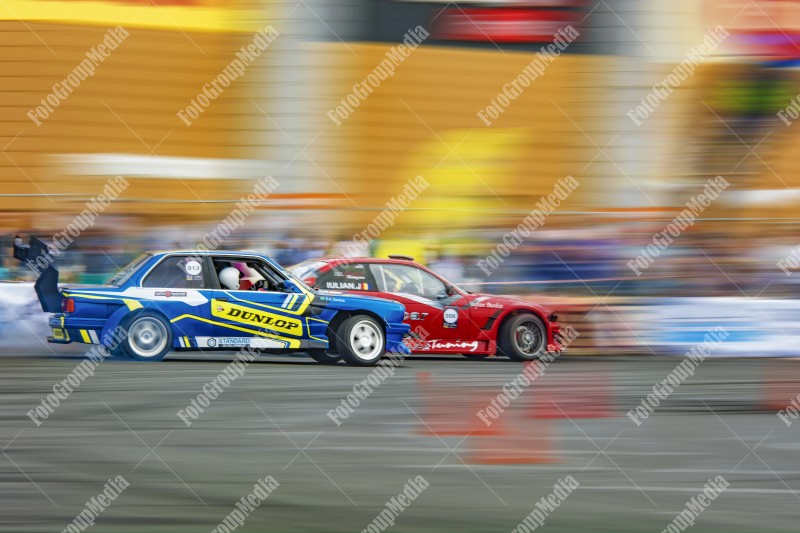 Two cars on track with smoke coming out of them